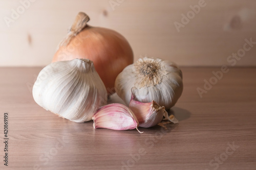 Garlic and onion on a wooden table. Soft focus