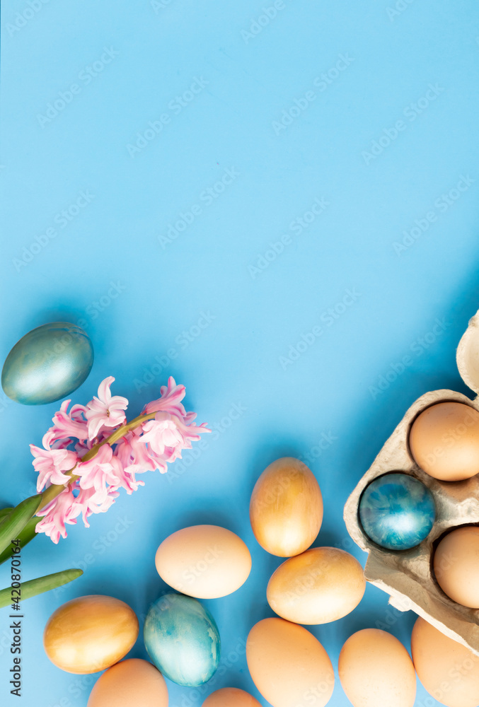 Easter eggs, flowers on blue background. Flat lay, top view, copy space. Easter day. Easter eggs, flowers on blue background. Flat lay, top view, copy space. Easter day.