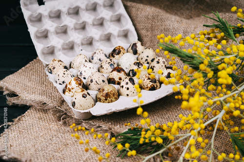 Quail eggs in eco-friendly packaging. The package of quail eggs lies on the burlap. photo