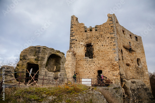 Stone gothic ruins of old rock medieval castle Valecov in sunny winter day before Christmas, ancient fortress on the top of the hill, Bohemian Paradise, Bosen, Czech Republic