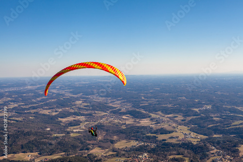 sports paragliding on a parachute over the countryside