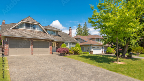 A perfect neighbourhood. Houses in suburb at Summer in the north America. Luxury houses with nice landscape. © karamysh