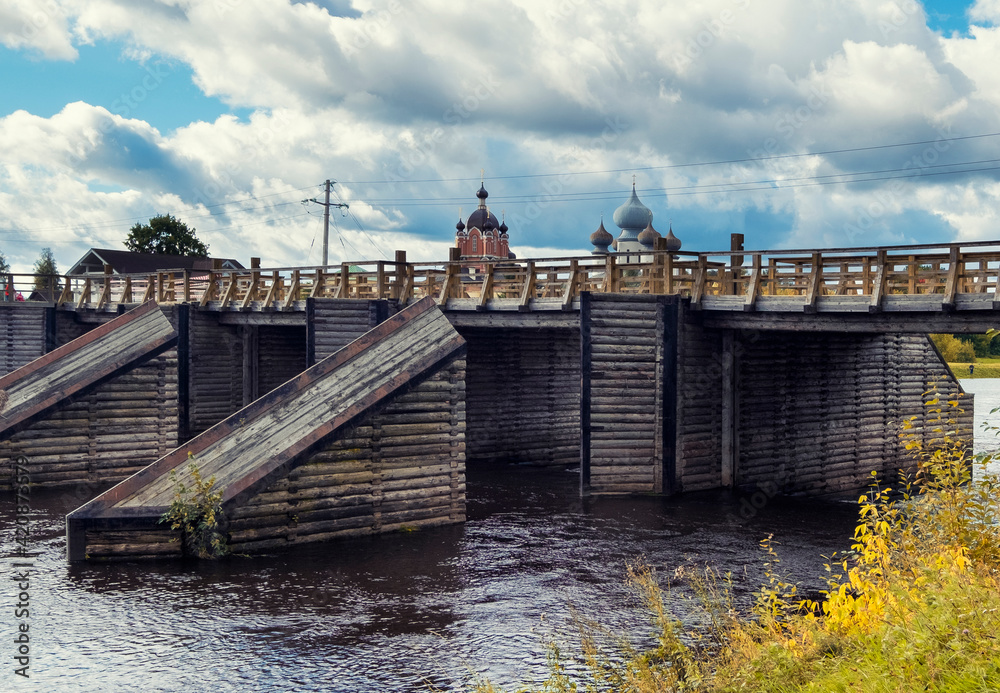 Fototapeta premium Tikhvin Bogorodichny Uspensky Male Monastery and a wooden bridge in Russia Leningrad region