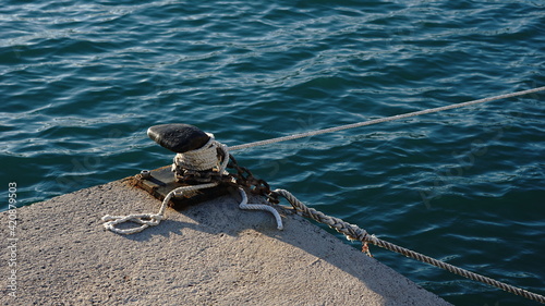 black mooring pylon with white rope
