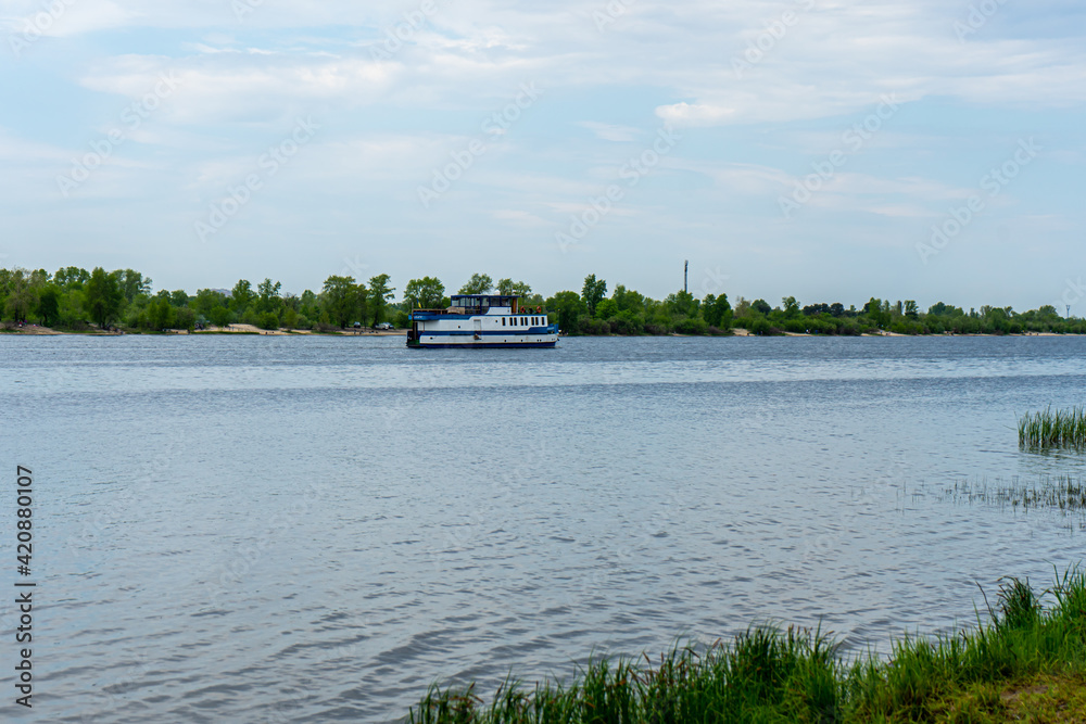 Panoramic landscape view of Dnipro river and tourists ship, Kyiv 