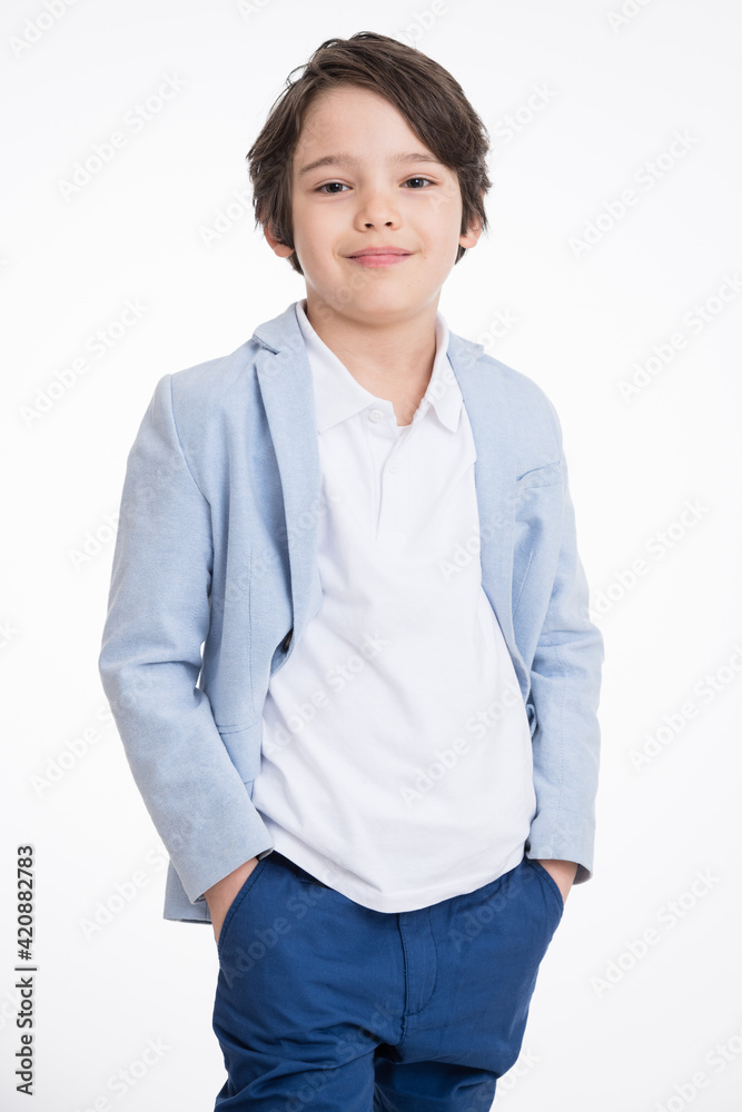 Young happy boy in suit posing over white background Young happy boy in suit posing over white background