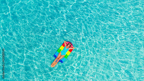 Aerial view. Beautiful woman wearing blue bikini. Happy and enjoying beach relaxing joyful in summer by tropical blue water.A sexy young girl.Holiday person.Amazing sea nature background.