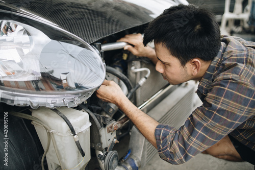 Asian mechanic is car repair in car garage  © anut21ng Stock