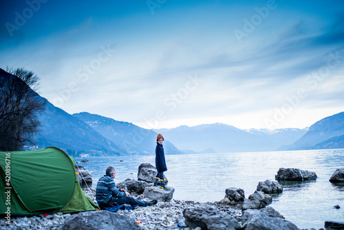 Father and son camping by lakeside, Onno, Lombardy, Italy