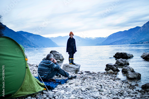 Father and son camping by lakeside, Onno, Lombardy, Italy