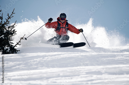 Male skier swerve skiing down mountain, Alpe-d'Huez, Rhone-Alpes, France
