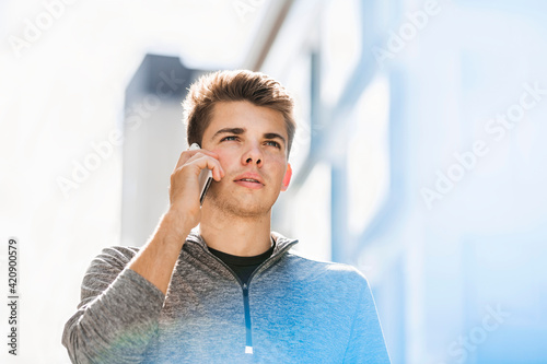 Young man using smartphone in city