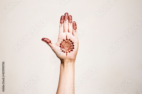 Hand with henna tattoo making gesture photo