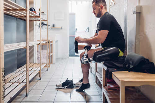 Man with prosthetic leg in gym changing room photo