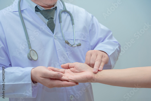 Doctor shook the patient hand to check the heart rate