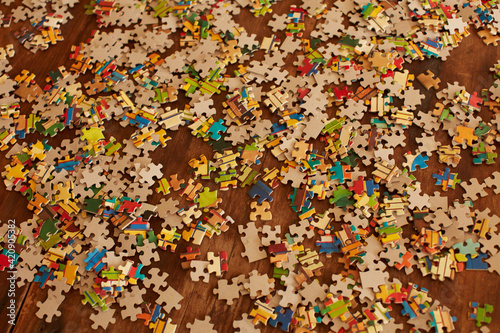 Jigsaw puzzle pieces on wooden floor