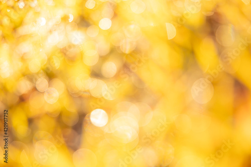 Golden blur abstract background. Yellow Bokeh Christmas blurred beautiful shiny Christmas lights.