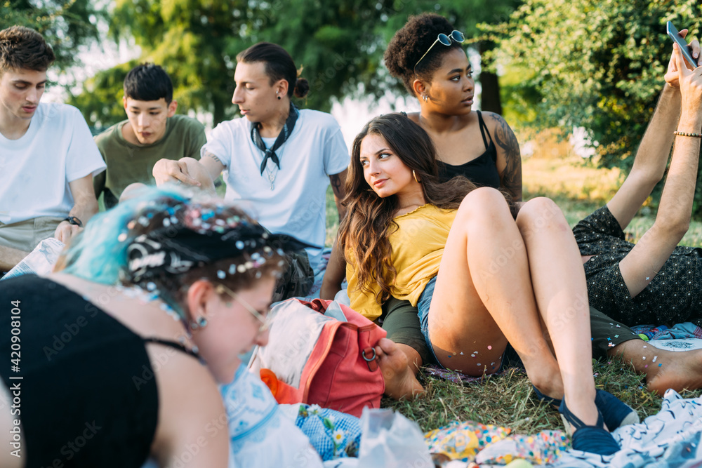 Group of friends relaxing at picnic in park Group of friends relaxing at picnic in park