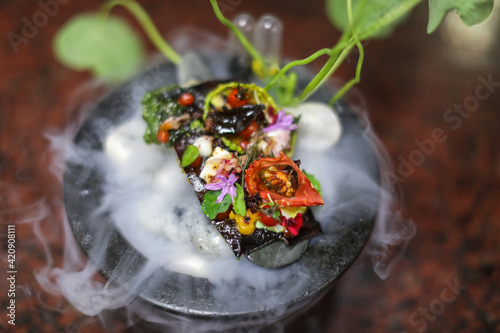 Exotic dish of vegetables and flowers photo