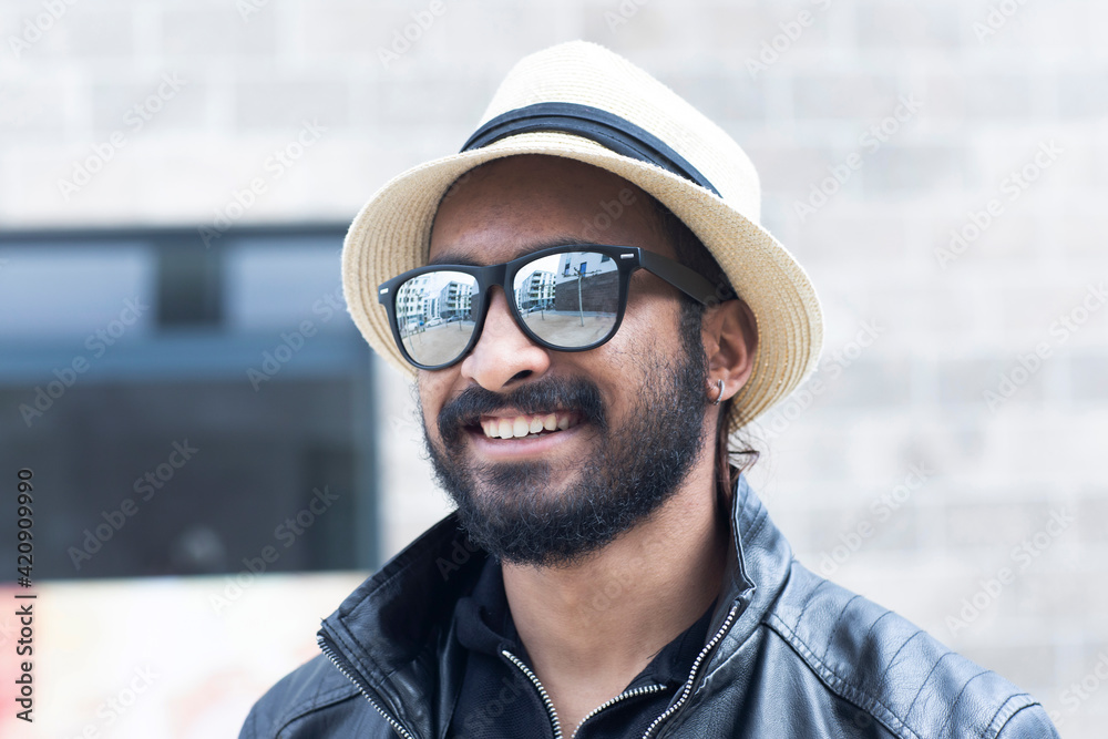 Portrait of smiling man with hat and sunglasses Portrait of smiling man with hat and sunglasses