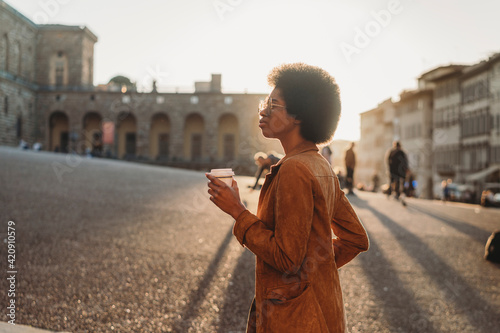 Young woman with afro hair exploring city, Florence, Toscana, Italy
