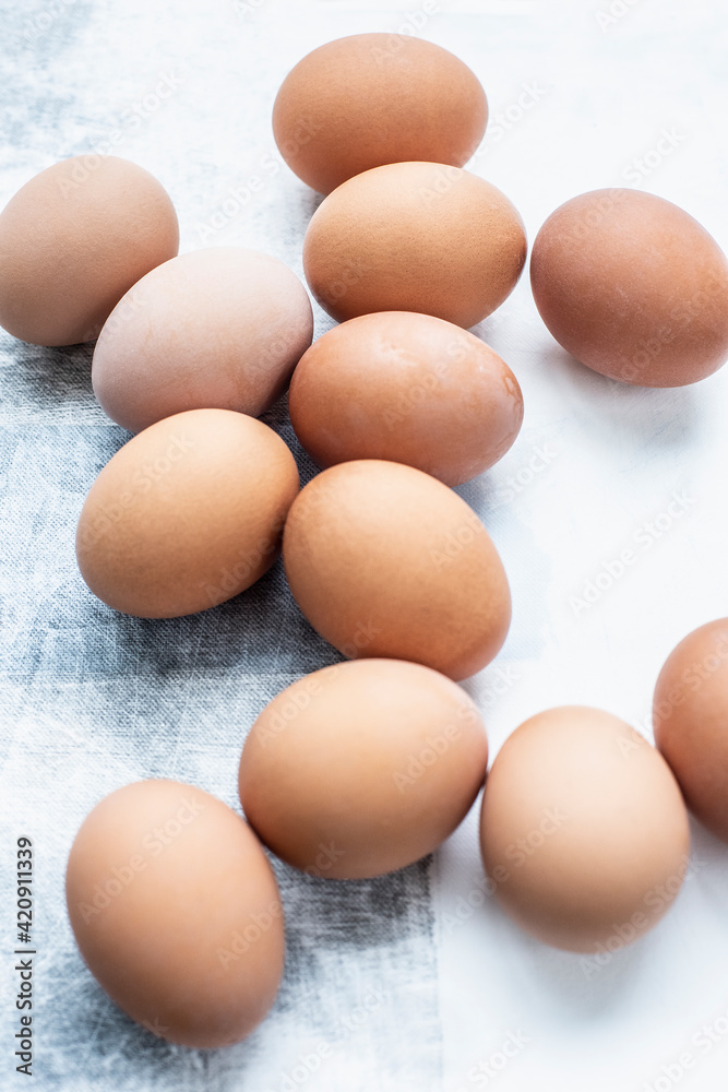 Still life of a dozen eggs on table, overhead view Still life of a dozen eggs on table, overhead view