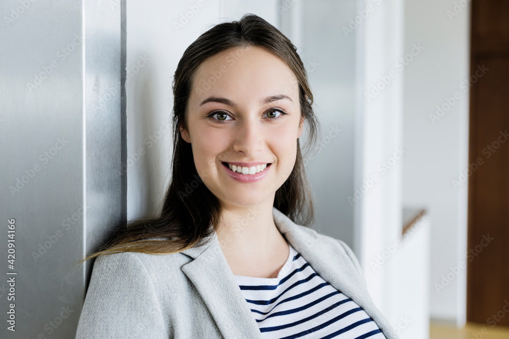 Businesswoman leaning against elevator door Businesswoman leaning against elevator door