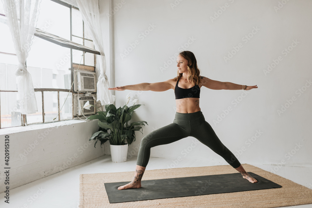 Woman practising yoga in studio Woman practising yoga in studio