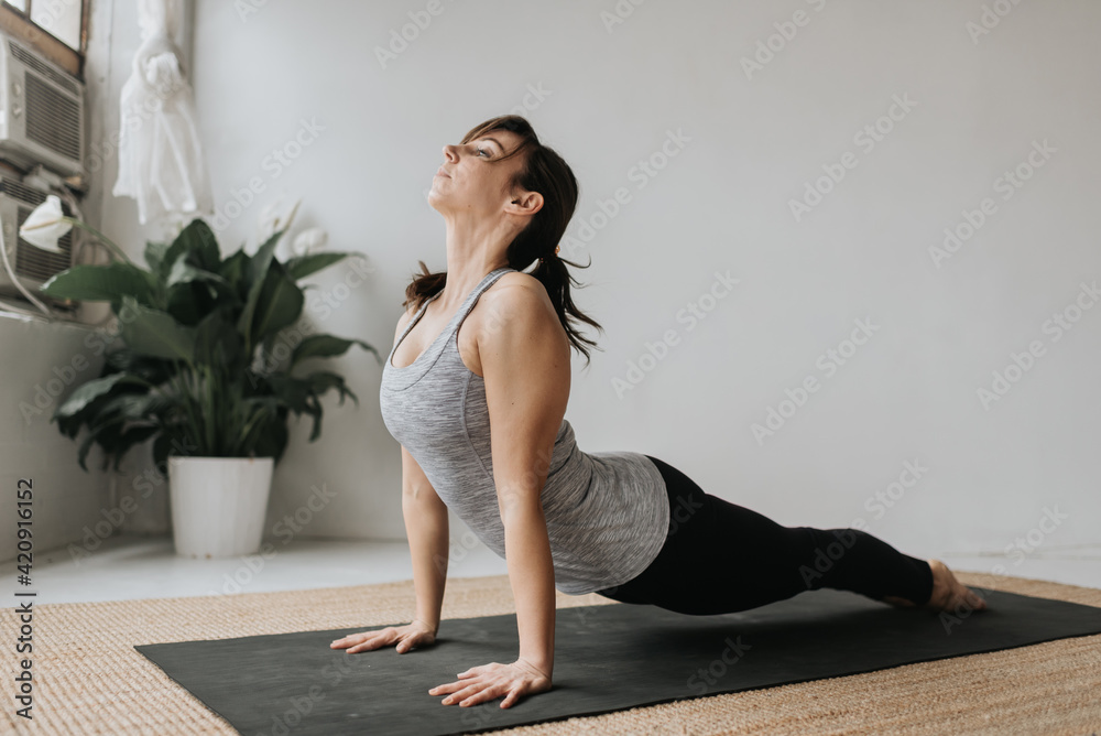 Woman practising yoga in studio Woman practising yoga in studio