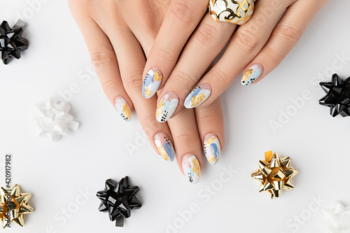 Young adult woman's hands with fashionable nails on white background. Spring summer nail design.
