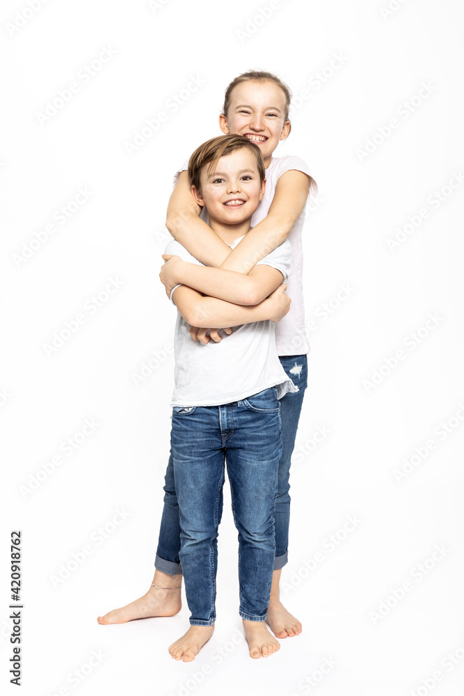 Girl hugging brother from behind, white background Girl hugging brother from behind, white background