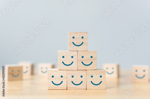 Wooden cube block shape with icon face smiley, The best excellent business services rating customer experience, Satisfaction survey concept photo