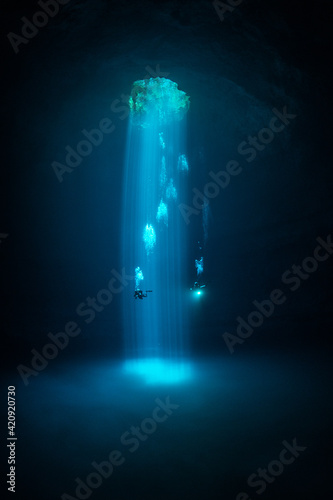Divers exploring Cenote Maravilla, Mexico