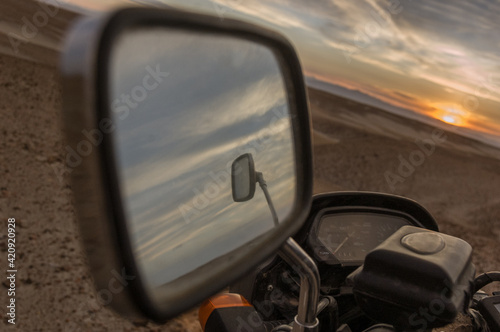 Mirror image of rear view mirror, sunset in background