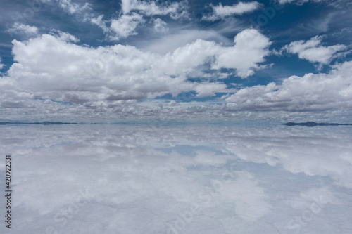 View of clouds scudding across a sky reflected in the lake below.