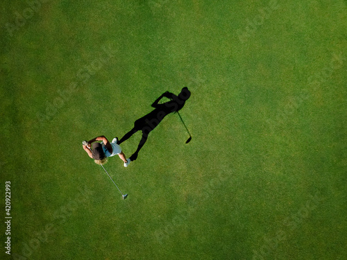 Woman playing golf on golf course