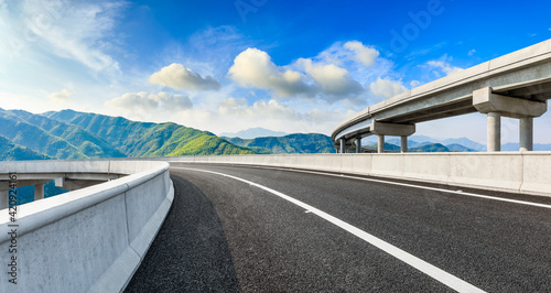Asphalt highway and green mountains in summer. © ABCDstock