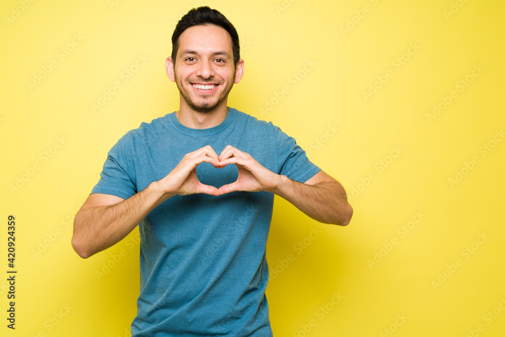Cheerful hispanic man offering his love to someone Cheerful hispanic man offering his love to someone