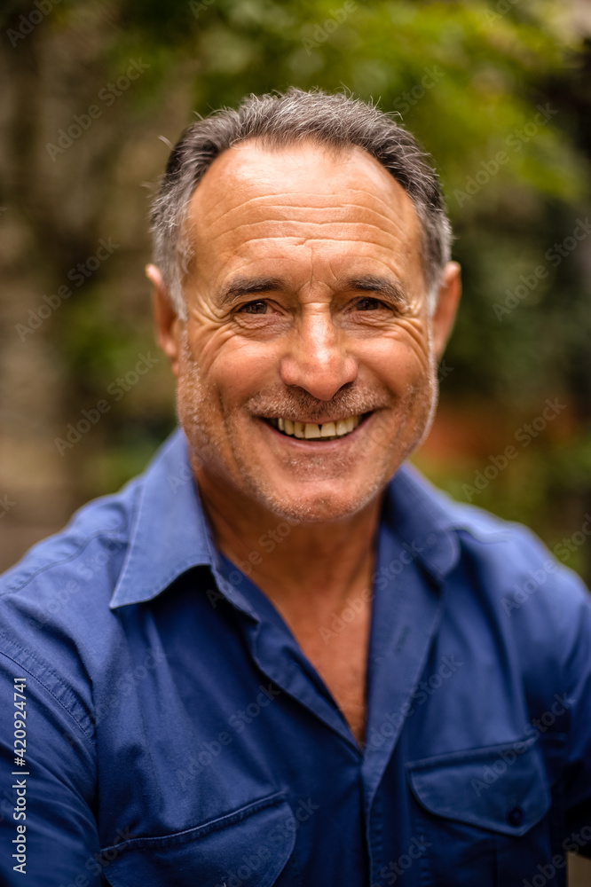 Head and shoulders portrait of mature man smiling at camera. Head and shoulders portrait of mature man smiling at camera.
