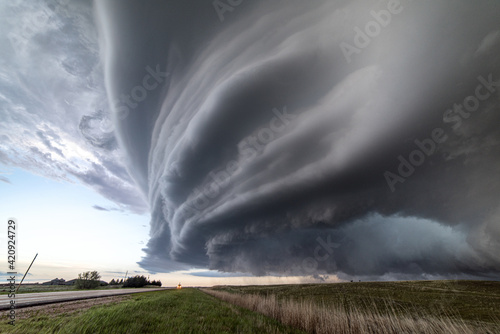 Sculpted super-cell, a mesocyclone weather formation thunderstorm clouds, drifting majestically across the Nebraska sand hills. photo