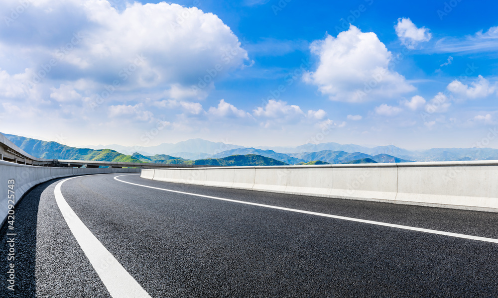 Fototapeta premium country road and green mountains in summer.