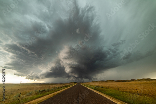 Incredible supercell spinning across Wyoming, sky full of dark storm clouds photo