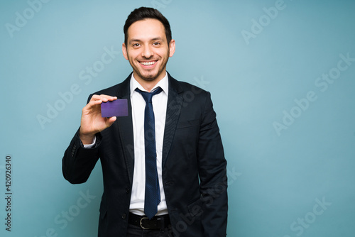 Good-looking man holding a purple credit card photo