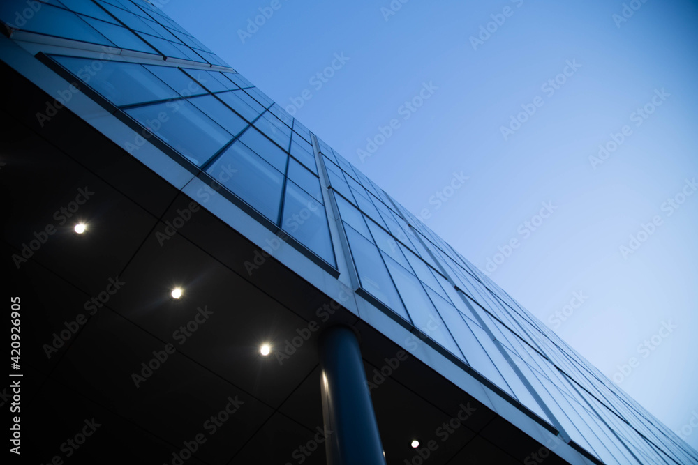 Low angle exterior view of glass facade of modern skyscraper. Low angle exterior view of glass facade of modern skyscraper.