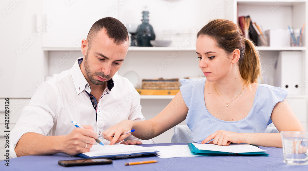 Fototapeta premium Man with his wife are sad about loans at home.