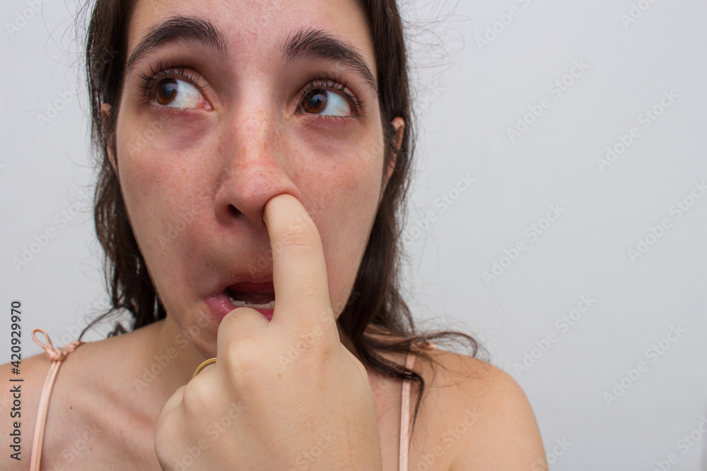 photo taken on white background in studio of woman poking her nose photo taken on white background in studio of woman poking her nose
