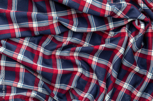 Background with crumpled fabric in checkered. Crumpled checkered fabric.
