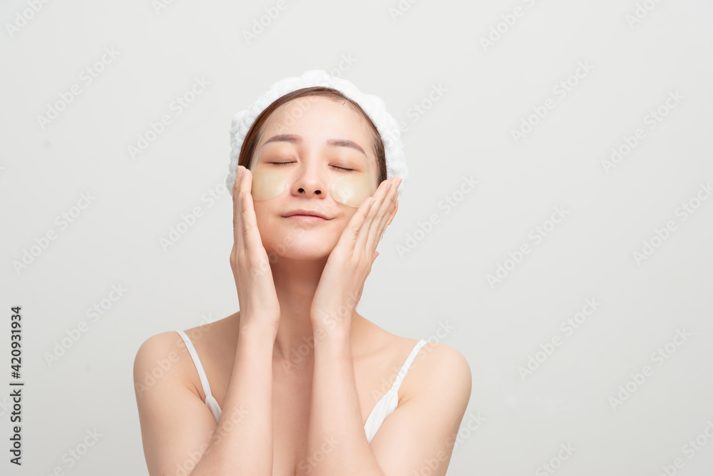 Beauty model face with healthy clean skin using under eye patches. Anti-aging moisturizer eye mask. Beauty model face with healthy clean skin using under eye patches. Anti-aging moisturizer eye mask.