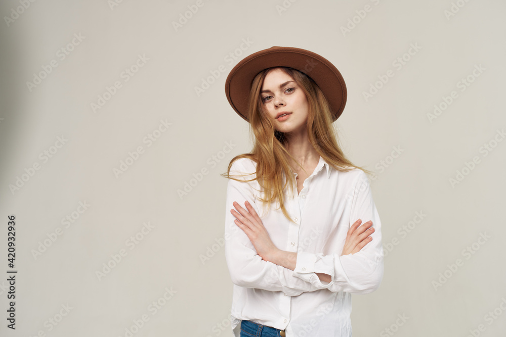 Pretty woman in hat white shirt elegant style fashion light background Pretty woman in hat white shirt elegant style fashion light background