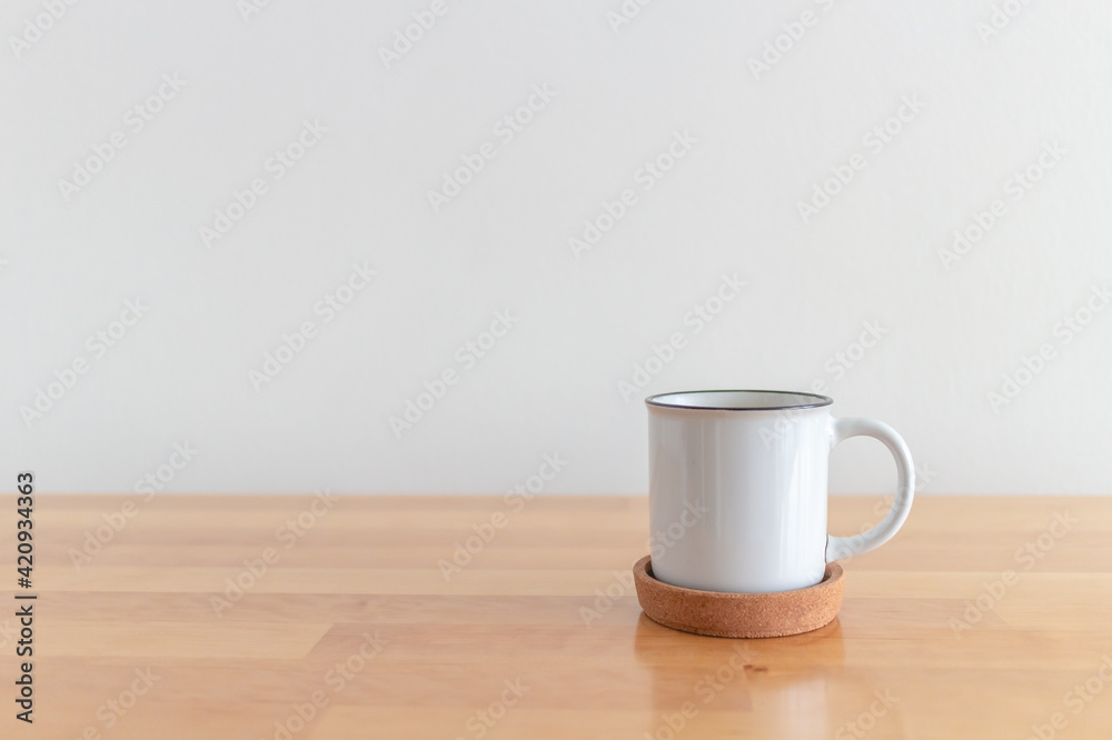 White cup of hot coffee mug on wooden table with isolate white background. White cup of hot coffee mug on wooden table with isolate white background.